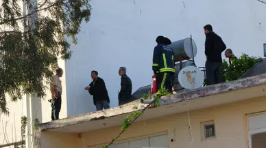 Antalya'da çatıya çıkan şahıs, gazeteciyle konuştuğu sırada polis tarafından aşağıya indirildi